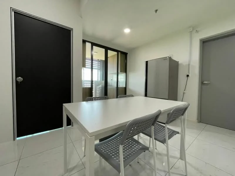 Dining features: white rectangular dining table, 4 grey plastic dining chairs, white tiled flooring, black door, glass sliding door, grey refrigerator, light fixture on ceiling, white walls; style: modern.
