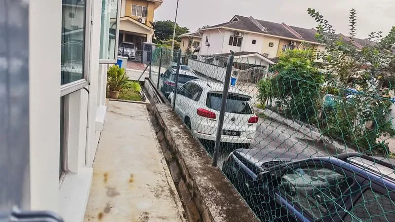 Exterior type: linked terrace house; features: concrete walkway, fenced perimeter, manicured landscaping, parking space for multiple vehicles, adjacent residential buildings, surrounding greenery; style: modern.