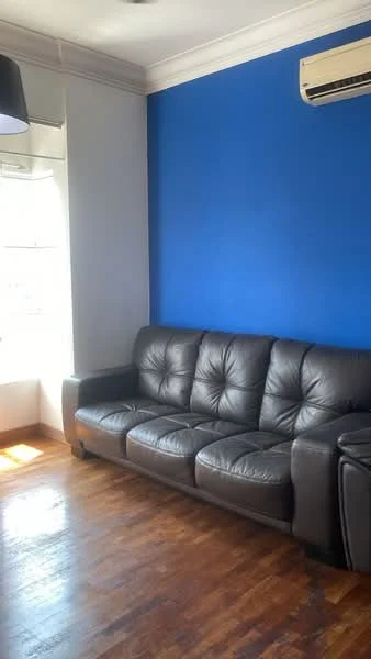 Living features: black leather sofa with tufted design, wooden flooring, blue painted accent wall, white painted walls, window with sheer curtains, wall-mounted split AC, ceiling light fixture; style: modern.