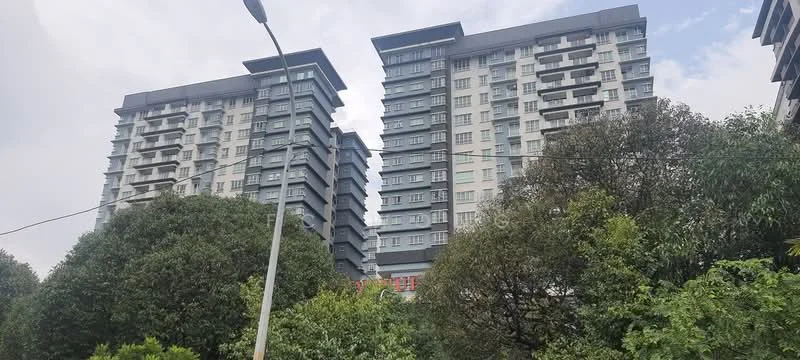 Exterior type: high-rise condominium; features: glass curtain wall, grey painted facade, recessed balconies, multiple storeys, surrounded by greenery, urban context; style: modern.
