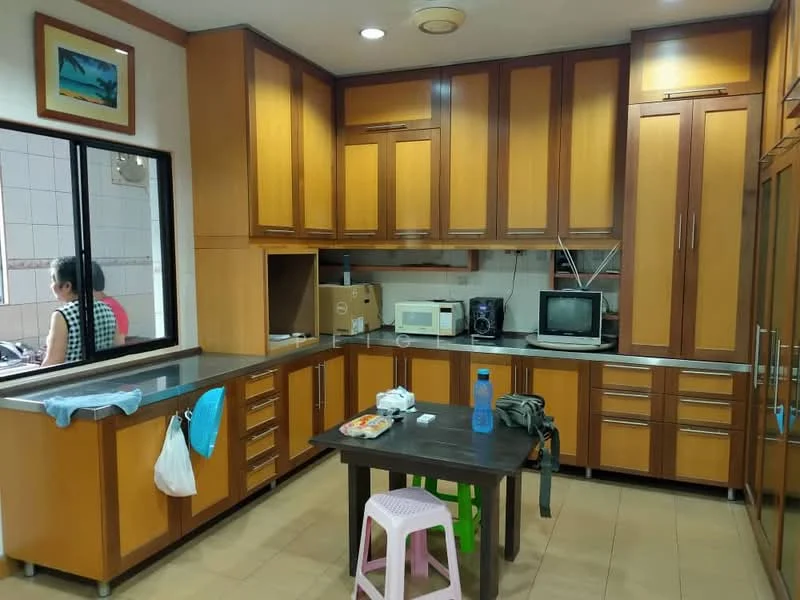 Kitchen features: brown wooden cabinetry, stainless-steel sink, chrome pull-down faucet, black countertop, built-in microwave, freestanding microwave, television, ceramic tile flooring, window with view to outside, table with plastic chairs, kitchen utensils on countertop, wall-mounted shelving; style: modern.
