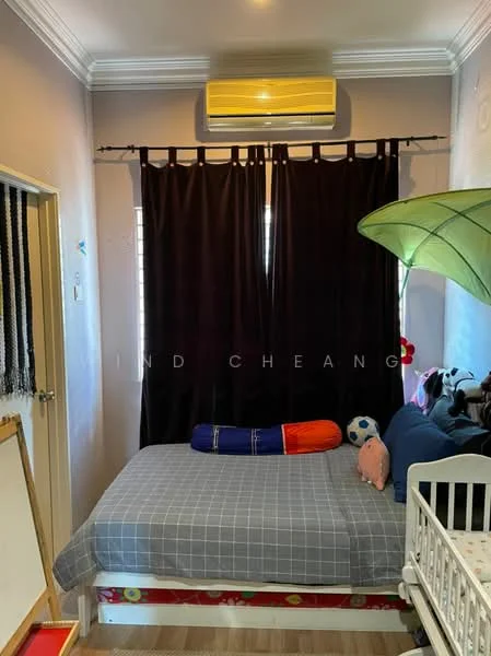 Bedroom features: single bed with grey bedding, blackout curtains, wall-mounted split AC unit, decorative green lamp, wooden flooring, children's toys, framed artwork on wall, small white crib, drawing board, blue and red decorative pillows.