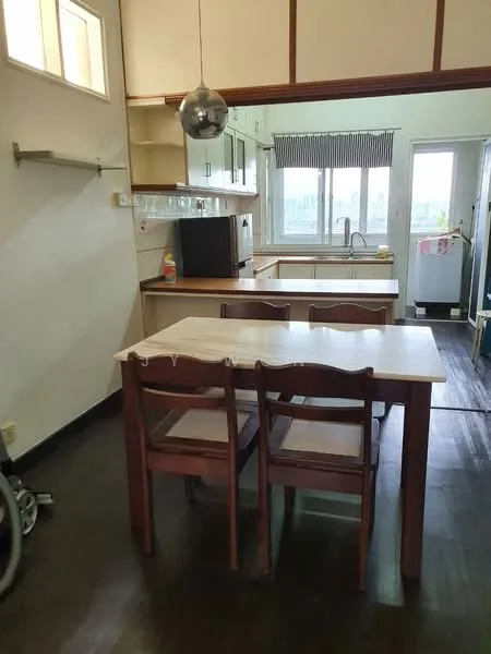 Kitchen features: wooden dining table with four chairs, pendant light fixture, white cabinetry, black countertop, built-in sink, window with blinds, refrigerator, open layout, dark wood flooring, kitchen island, wall-mounted shelf; style: modern; view: city.