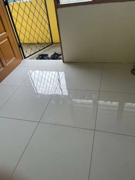 Room features: glossy ceramic tile flooring, yellow painted walls, wooden door, metal security grille door, natural light from window, visible footwear near entrance.