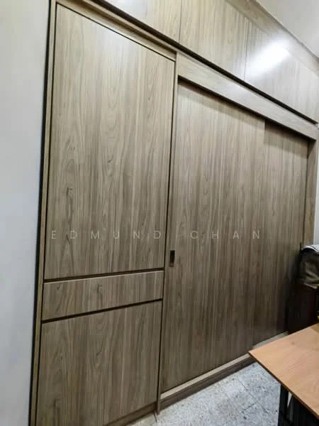Room features: wooden sliding door, built-in wardrobe with wood finish, drawer storage, textured wood paneling, light-colored flooring, wall-mounted desk, minimalist design; style: modern.