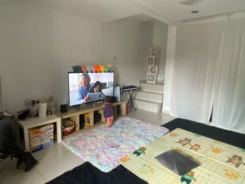 Living features: light grey painted walls, white ceiling, large flat-screen TV, TV console with storage, area rug with pastel colors, black carpet flooring, sofa with cushions, decorative shelving unit, folding table, child playing on the floor; style: modern.