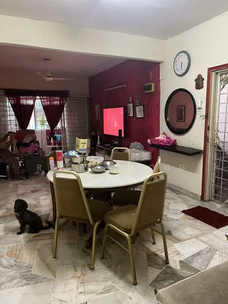 Living features: round dining table, 4 dining chairs, marble flooring, red accent wall, wall-mounted TV, sofa, decorative mirror, ceiling fan, window with sheer curtains, wall clock, open doorway, dog on floor.