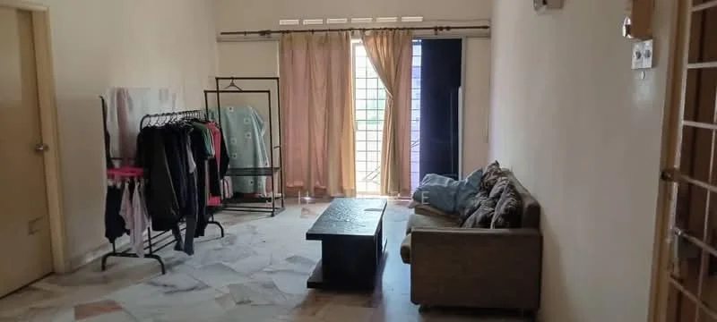 Living features: sofa in beige fabric, coffee table, marble flooring, floor-to-ceiling windows, sheer curtains, clothes rack with hanging clothes, light wall paint, door leading outside.