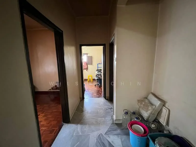 Hallway features: grey marble flooring, cream painted walls, wooden door frames, light fixture on ceiling, open doorway leading to another room, decorative wall molding; style: traditional. Room features: wooden flooring, light coming from window, furniture visible in background.