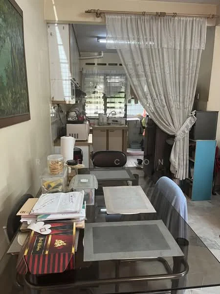 Dining features: glass dining table, 4 dining chairs, table placemats, decorative wall art, curtains, tile flooring, wall-mounted cabinet, open kitchen view. Kitchen features: kitchen cabinets, sink, countertop, stove, kitchen utensils visible, window, appliances visible.