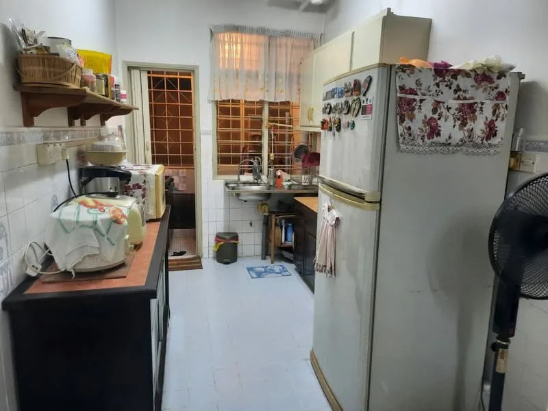 Kitchen features: white tiled walls, light blue tiled flooring, wooden countertop, fridge, microwave, kitchen sink, wall-mounted shelves, window with sheer curtains, ceiling fan, wooden cabinet, decorative cloth on fridge.