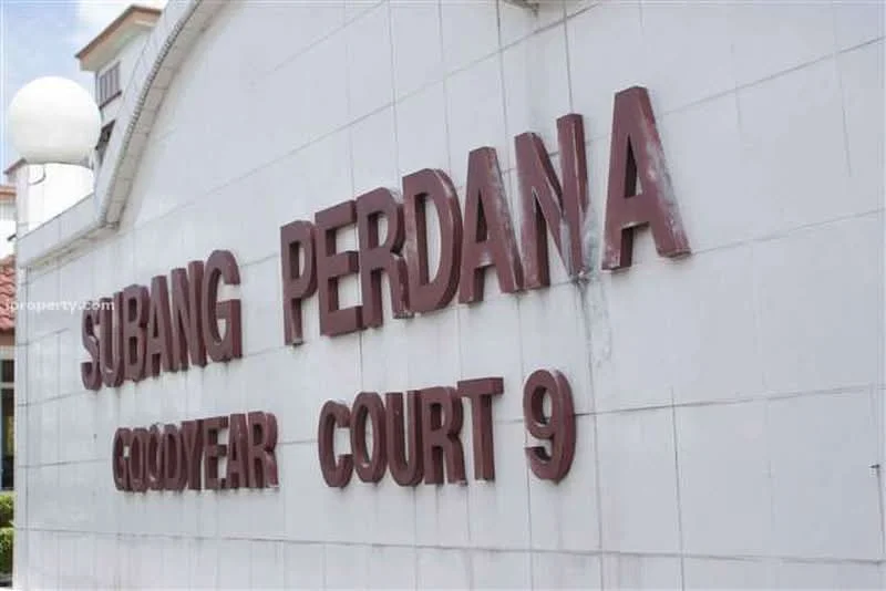 Exterior features: white painted facade, large lettering, signage for 'Subang Perdana Goodyear Court 9', outdoor lighting fixtures; style: modern.