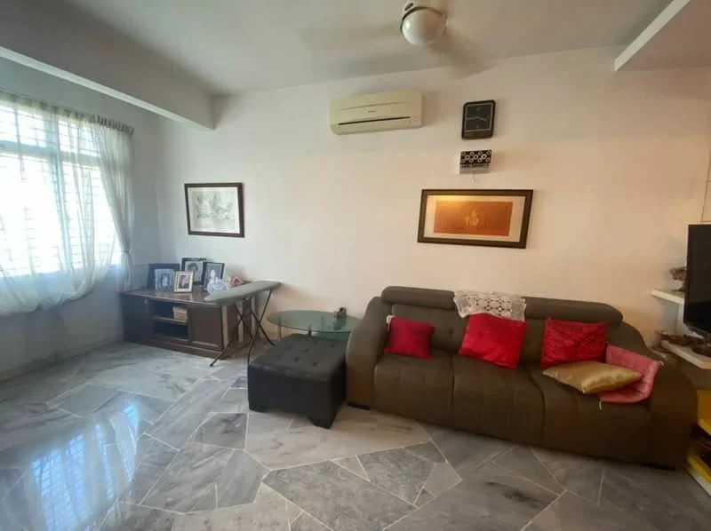 Living features: grey marble flooring, white painted walls, ceiling fan, large window with sheer curtains, brown leather sofa with red and gold cushions, glass coffee table, wooden side table, framed artwork on walls, air conditioning unit; style: modern.
