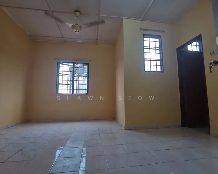 Room features: yellow painted walls, white tiled flooring, ceiling fan, two windows with grid design, single wooden door, light from windows, no visible furniture.
