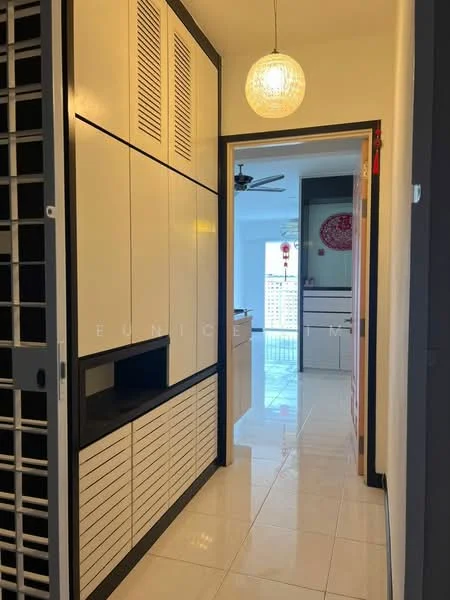 Hallway features: white painted walls, glossy tile flooring, built-in cabinetry with horizontal slats, pendant light fixture, doorway leading to kitchen, ceiling fan, window with city view, decorative wall art; style: modern; view: city. Kitchen features: white cabinetry, glossy tile flooring, countertop with backsplash, stainless-steel appliances, open layout, window with natural light; style: modern; view: city.