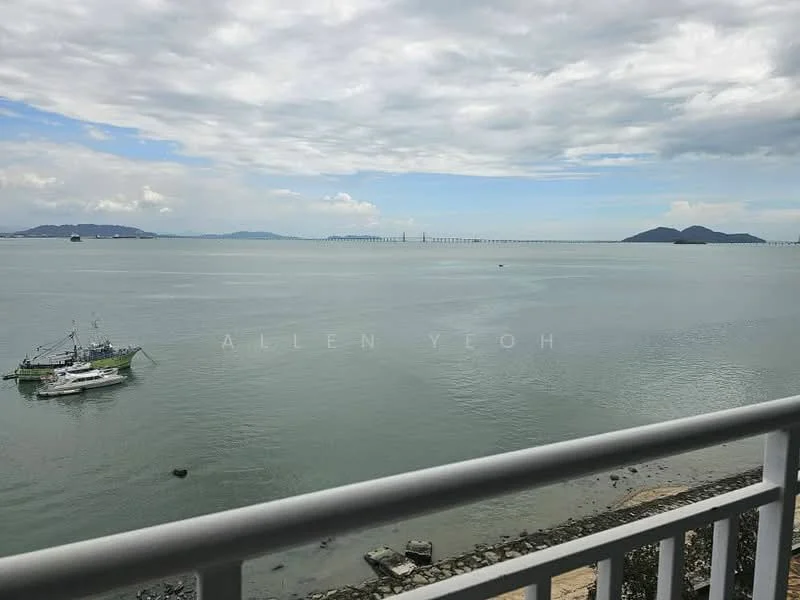 Exterior features: waterfront view, sea view, distant islands, fishing boat, pier in the background, rocky shoreline, cloudy sky.