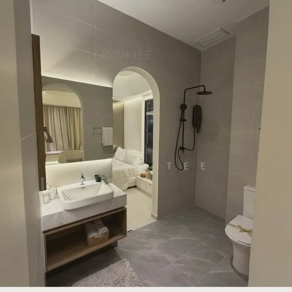 Bathroom features: single-sink vanity with wood cabinet, white ceramic sink, chrome basin mixer, framed mirror, one-piece toilet, walk-in shower with glass enclosure, rain shower head, grey tile flooring, light grey wall tiles, towel rack, white bath mat; style: modern.