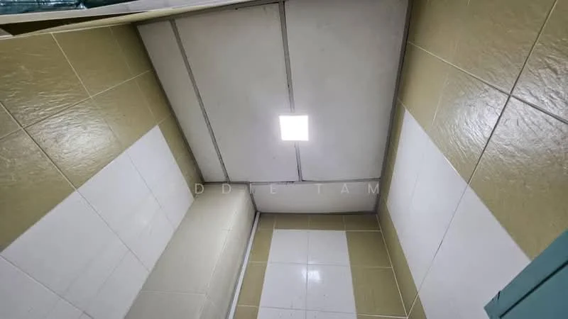Room features: white tiled walls, beige tiled walls, plain ceiling, flush-mounted ceiling light, grouted tile joints, no visible fixtures.