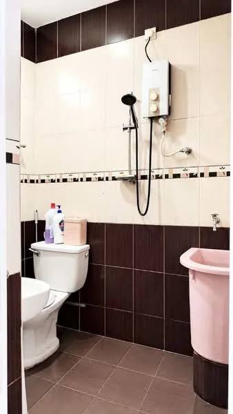 Bathroom features: white ceramic toilet, pink waste bin, shower head with wall-mounted holder, water heater, brown tiled walls, cream tiled walls, black and cream decorative border tile, brown tile flooring; style: modern.