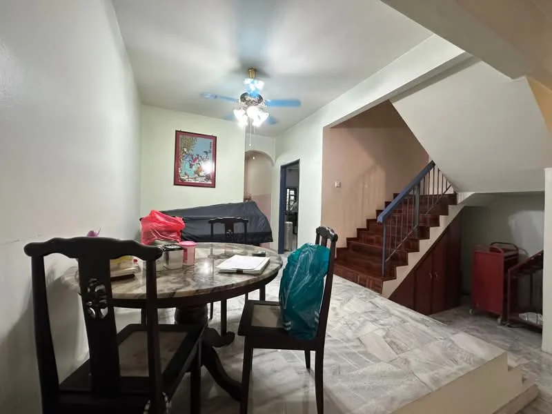 Dining features: round dining table with marble top, 4 wooden dining chairs, ceiling fan with light, white painted walls, marble tile flooring, decorative wall art, staircase visible in background, open layout to living area; style: modern. Room features: staircase with wooden steps, wooden cabinets in background, black sofa visible in background.