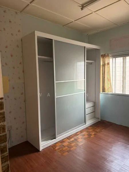 Room features: built-in wardrobe with sliding doors, white cabinetry, wooden flooring, wall with floral wallpaper, window with sheer curtains, ceiling with fluorescent lights.