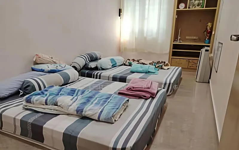 Bedroom features: two single beds with striped bedding, light-coloured walls, large window with sheer curtains, built-in wardrobe, laminate flooring, decorative items on shelves, folded blankets, plush toys on the bed.