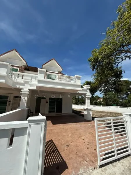 Exterior type: semi-detached house; features: white painted facade, recessed balconies, gabled roof, front porch area, manicured lawn, fenced perimeter, two-storey structure, large windows, greenery in background; style: modern.