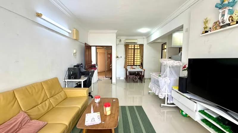 Living features: yellow leather sofa, wooden coffee table, green area rug, white painted walls, glossy tile flooring, recessed ceiling lights, wall-mounted TV, decorative shelves with trophies, open layout to kitchen, air conditioning unit; style: modern. Room features: doorway leading to other rooms, visible kitchen area, light-colored walls.