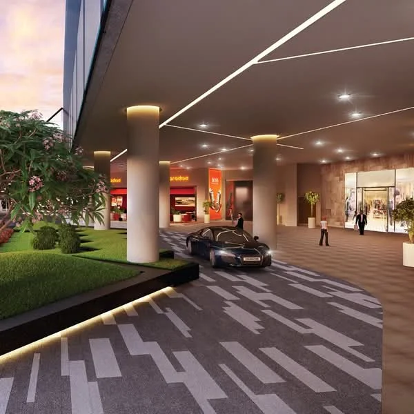 Exterior type: high-rise condominium; features: covered parking area, manicured landscaping, paved driveway with geometric pattern, large glass entrance, outdoor lighting, decorative planters, modern architectural design, multiple columns supporting the structure; style: modern.