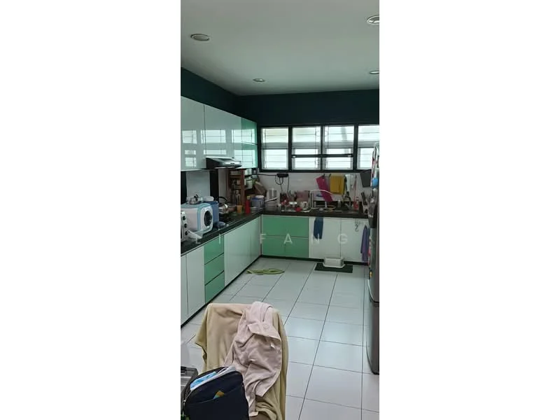 Kitchen features: green and white cabinetry, white tiled flooring, double-bowl stainless-steel sink, chrome pull-down faucet, built-in oven, freestanding washing machine, countertop with space for appliances, multiple kitchen utensils and items visible, three windows for natural light, recessed ceiling lights; style: modern.