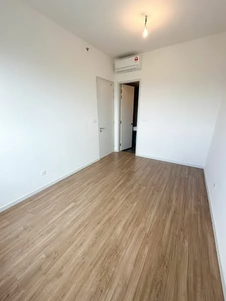 Room features: light wood laminate flooring, white painted walls, single light bulb ceiling fixture, wall-mounted split AC unit, door leading to another room, window with no visible treatment; style: modern.