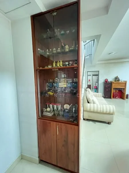 Room features: wooden display cabinet with glass doors, decorative items inside cabinet, white walls, tile flooring, open space leading to another room, natural light from nearby windows; style: modern.