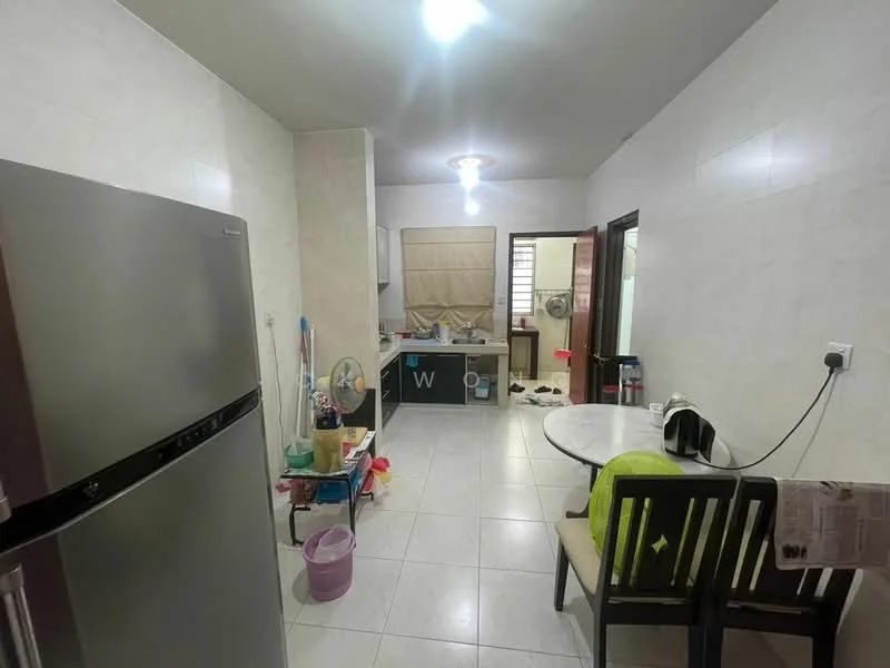 Kitchen features: stainless-steel fridge, white tiled walls, white tiled flooring, ceiling light fixture, round dining table, two wooden dining chairs, kitchen cabinets, sink, countertop, window, cleaning supplies, kitchen appliances.