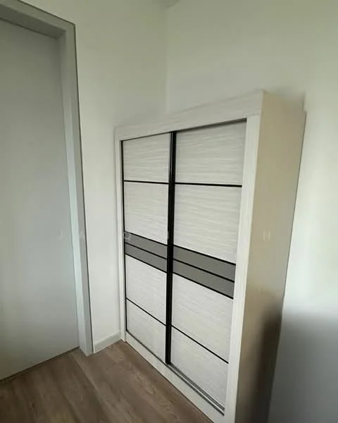 Room features: built-in wardrobe with sliding doors, light wood finish, black accent panels, laminate flooring, neutral wall color; style: modern.