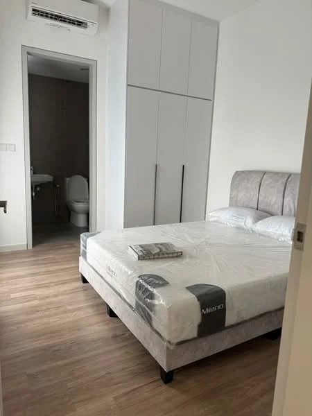 Bedroom features: queen-size bed with upholstered headboard, wooden flooring, built-in wardrobe with sliding doors, natural light from window, decorative magazine on bed; style: modern. Bathroom features: one-piece toilet, tile flooring, neutral wall tiles, sink with faucet, shower area, mirror above sink; style: modern.