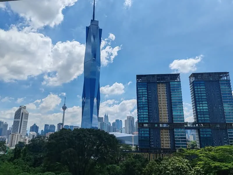Exterior type: high-rise condominium; features: glass curtain wall, modern architectural design, surrounded by greenery, city skyline view, prominent landmark tower, multiple high-rise buildings, urban context, open sky, clouds in the background; style: modern.
