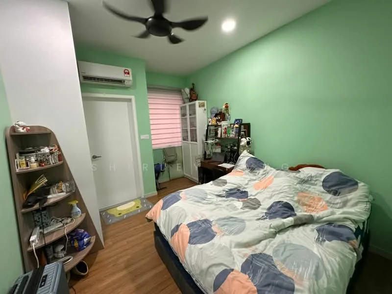Bedroom features: green painted walls, wood laminate flooring, queen-size bed with patterned bedding, 5-blade ceiling fan with light, wall-mounted air conditioning unit, window with blinds, study desk, wooden shelving unit, decorative items on shelves; style: modern.