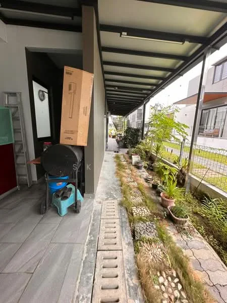 Room features: grey tiled flooring, metal roof with overhang, greenery along walkway, potted plants, box leaning against wall, blue cart, concrete pathway, fence visible in background; style: modern; view: garden.
