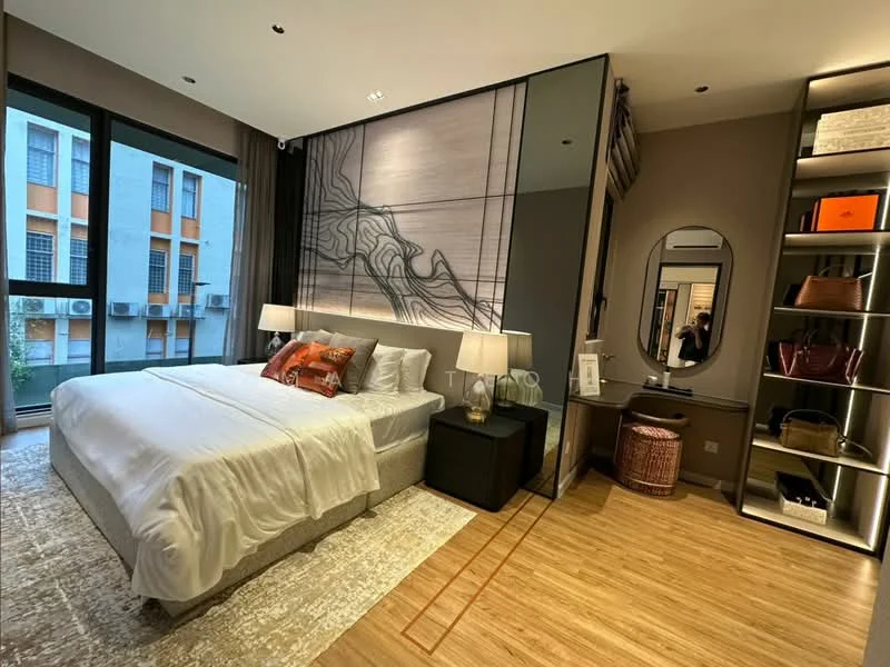 Bedroom features: king-size bed with white bedding, upholstered headboard, two bedside tables, table lamps on each bedside table, large windows with sheer curtains, wooden flooring, decorative wall art with abstract design, built-in wardrobe with open shelving, full-length mirror, area rug with neutral tones; style: modern; view: city.