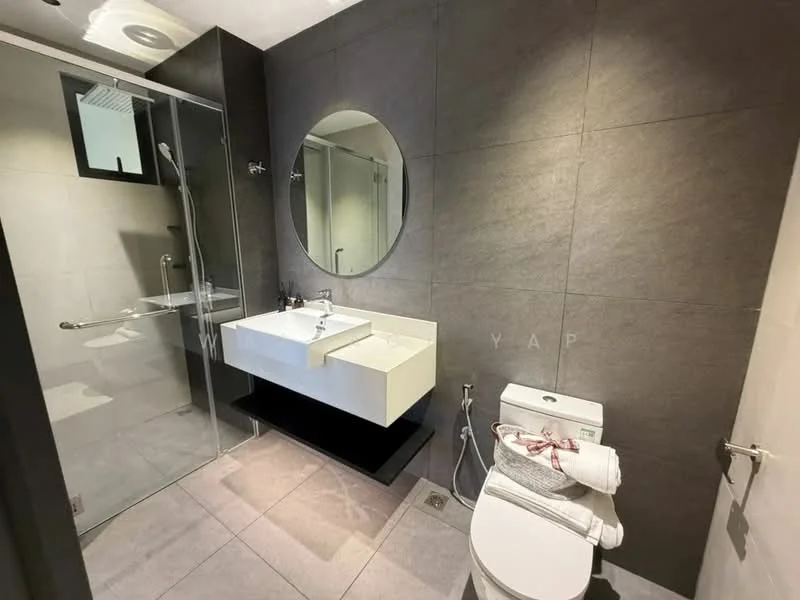 Bathroom features: grey tile walls, light grey tile flooring, walk-in shower with glass enclosure, rain shower head, handheld shower, floating vanity with double sink, chrome basin mixer faucets, round mirror, one-piece toilet, towel rack, white towels, window for natural light; style: modern.