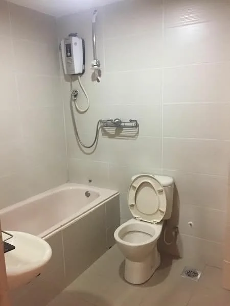 Bathroom features: bathtub, shower head, toilet, sink, white tiled walls, light grey tiled flooring, wall-mounted shower mixer, drainage grate; style: modern.