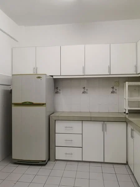 Kitchen features: white cabinetry with flat-panel doors, grey countertop, stainless-steel fridge, built-in cabinets, wall-mounted cabinets, tile backsplash, white tiled flooring, single-bowl stainless-steel sink, under-sink storage, decorative wall decals; style: modern.