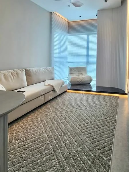 Living features: 3-seater fabric sofa in light beige, area rug with geometric pattern, floor-to-ceiling windows, sheer curtains, recessed downlights, ceiling fan, wall-mounted lighting, decorative wall paneling, glass coffee table; style: modern; view: city.