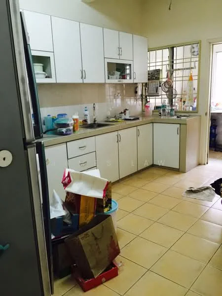 Kitchen features: white cabinetry with upper and lower storage, stainless-steel fridge, ceramic tile flooring, countertop with beige surface, sink with faucet, window with metal grille, various kitchen appliances visible, cluttered countertop with items, open layout to adjacent room.