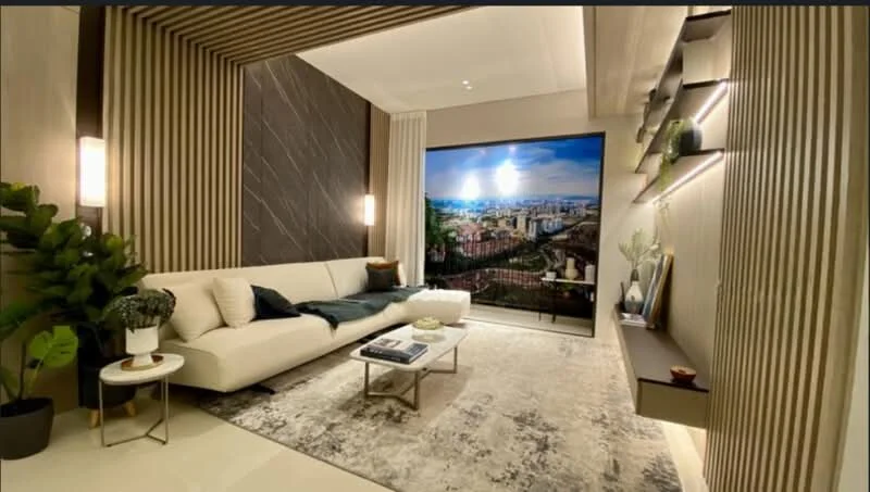 Living features: cream fabric sofa, decorative throw pillows, marble coffee table, area rug with geometric pattern, wall-mounted TV, feature wall with vertical wood slats, dark accent wall with marble finish, shelf with decorative items, indoor plant in ceramic pot, recessed lighting, large window with city view; style: modern; view: city.