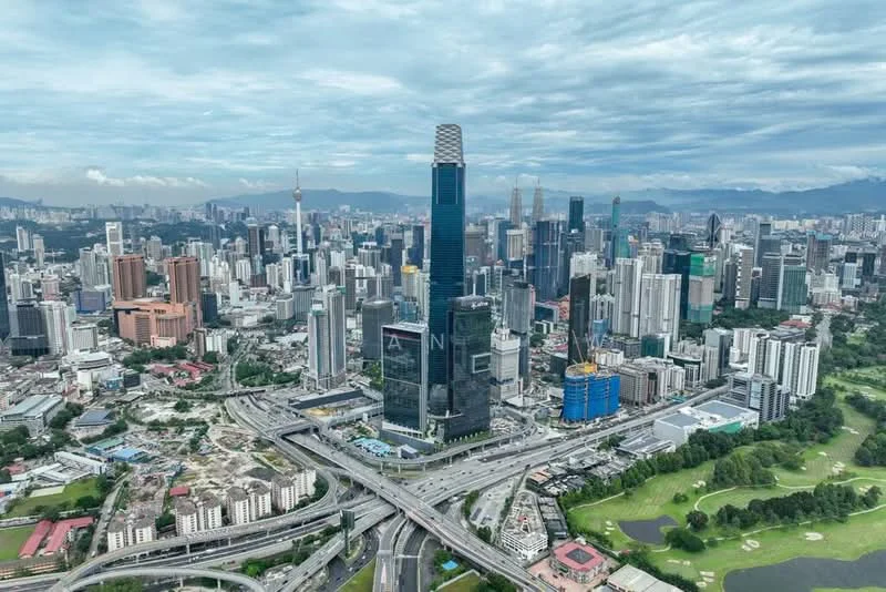 Exterior type: high-rise condominium; features: glass curtain wall, prominent skyscraper, surrounded by urban landscape, highway access, city skyline, green spaces in foreground; style: modern.