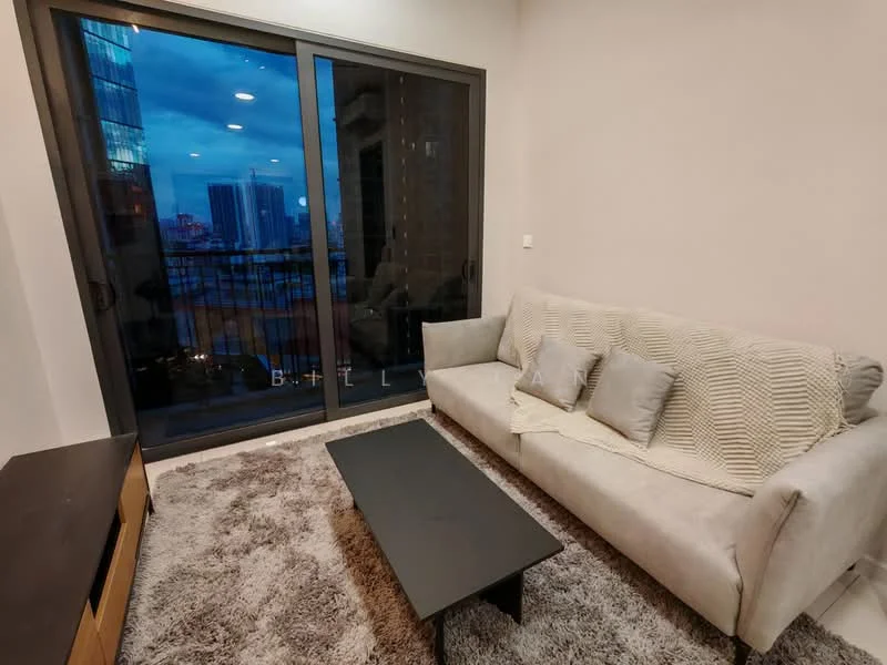 Living features: 3-seater fabric sofa in light grey, decorative throw pillows, black coffee table, area rug with soft texture, floor-to-ceiling sliding glass door, city skyline view, recessed ceiling lights, neutral painted walls; style: modern; view: city.