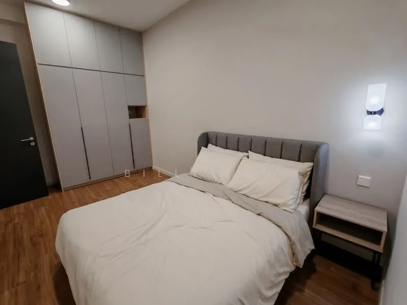 Bedroom features: queen-size bed with grey upholstered headboard, white bedding, light wood flooring, built-in wardrobe with grey cabinet doors, nightstand with lamp, wall-mounted light fixture, neutral painted walls, window with no visible treatment; style: modern.