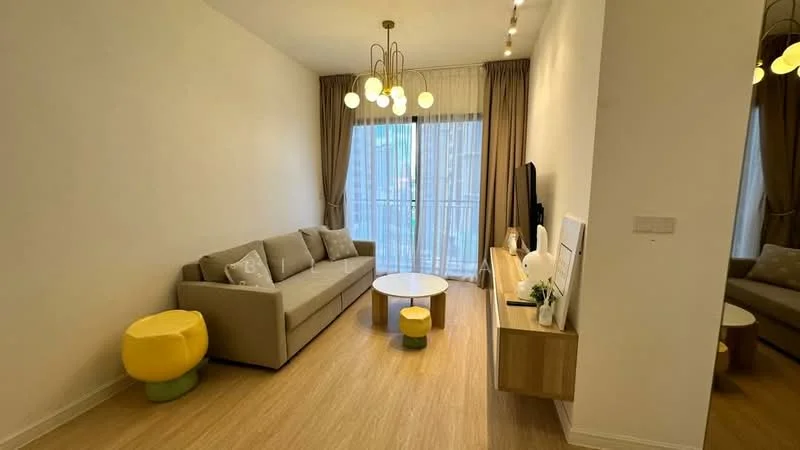 Living features: 3-seater fabric sofa in light grey, round coffee table with white top, wooden TV console, wall-mounted TV, floor-to-ceiling windows, sheer curtains, wooden flooring, 2 decorative pendant lights, yellow pouf, green pouf, decorative plants on console; style: modern.
