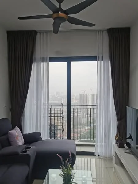 Living features: 3-seater fabric sofa in dark grey, ceiling fan with integrated light, floor-to-ceiling windows, sheer white curtains, dark brown curtains, glass coffee table, TV console, wall-mounted TV, decorative plant, marble tile flooring; style: modern; view: city.